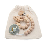 Handcrafted Ava & Bear Dummy Clip and Teether Toy Set, featuring a stylish dummy chain to keep pacifiers within reach and a soothing teether made from safe silicone and wood, perfect for easing teething discomfort.
