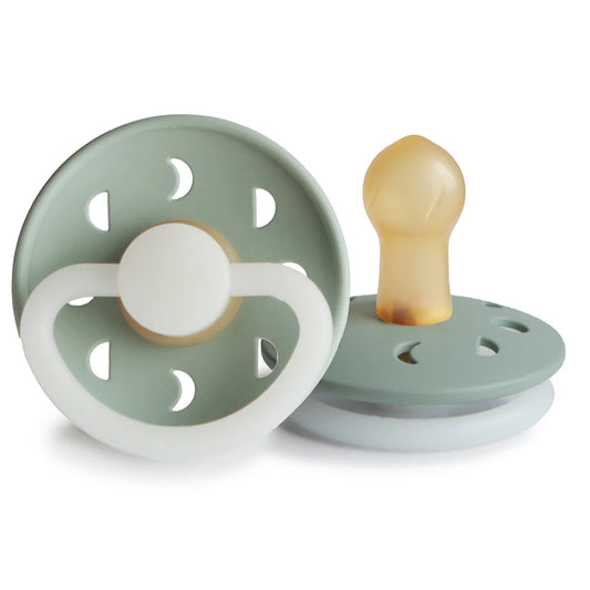 FRIGG Moon Night Pacifier by Ava & Bear, glowing softly with lunar phase designs, creating a serene atmosphere for your child's restful sleep.