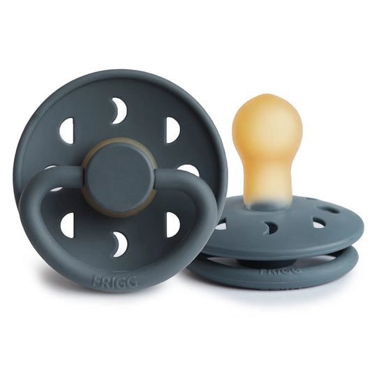 Celestial-themed FRIGG Moon pacifier by Ava & Bear, showcasing a soothing lunar design that adds a comforting glow to your baby's crib environment.